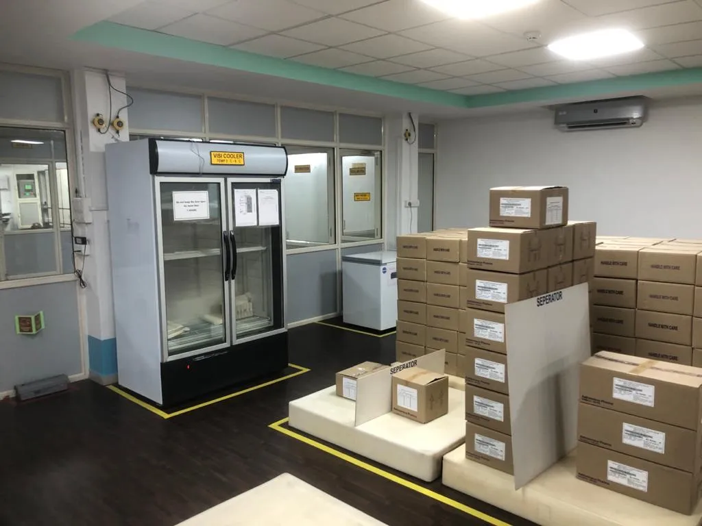 Pharma cold room with a vaccine refrigerator and medicine cartons