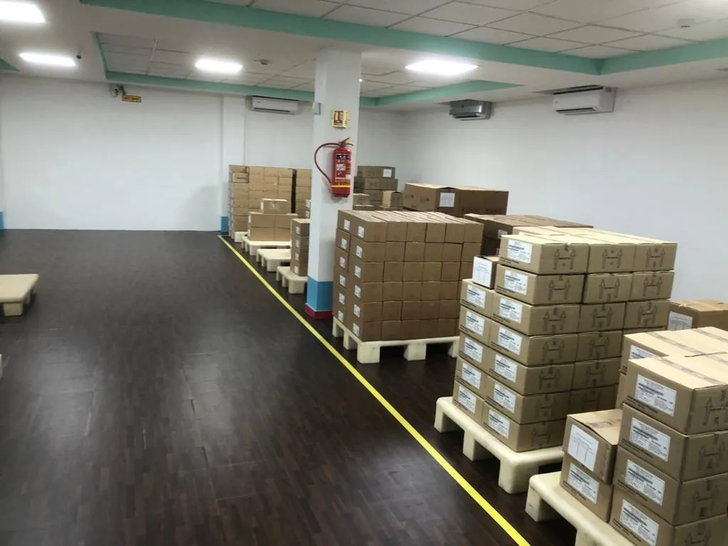 Medicine cartons on pallets in a clean, air-conditioned store room